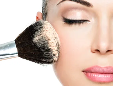 closeup-portrait-of-a-woman-applying-dry-cosmetic-tonal-foundation-on-the-face-using-makeup-brush.jpg