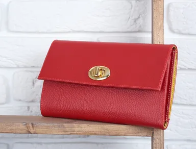 red-woman-s-leather-clutch-laying-on-the-wooden-shelf-on-white-wall-in-the-shop-perfect-for-everyday-casual-look-and-for-pretty-cocktail-dress.jpg